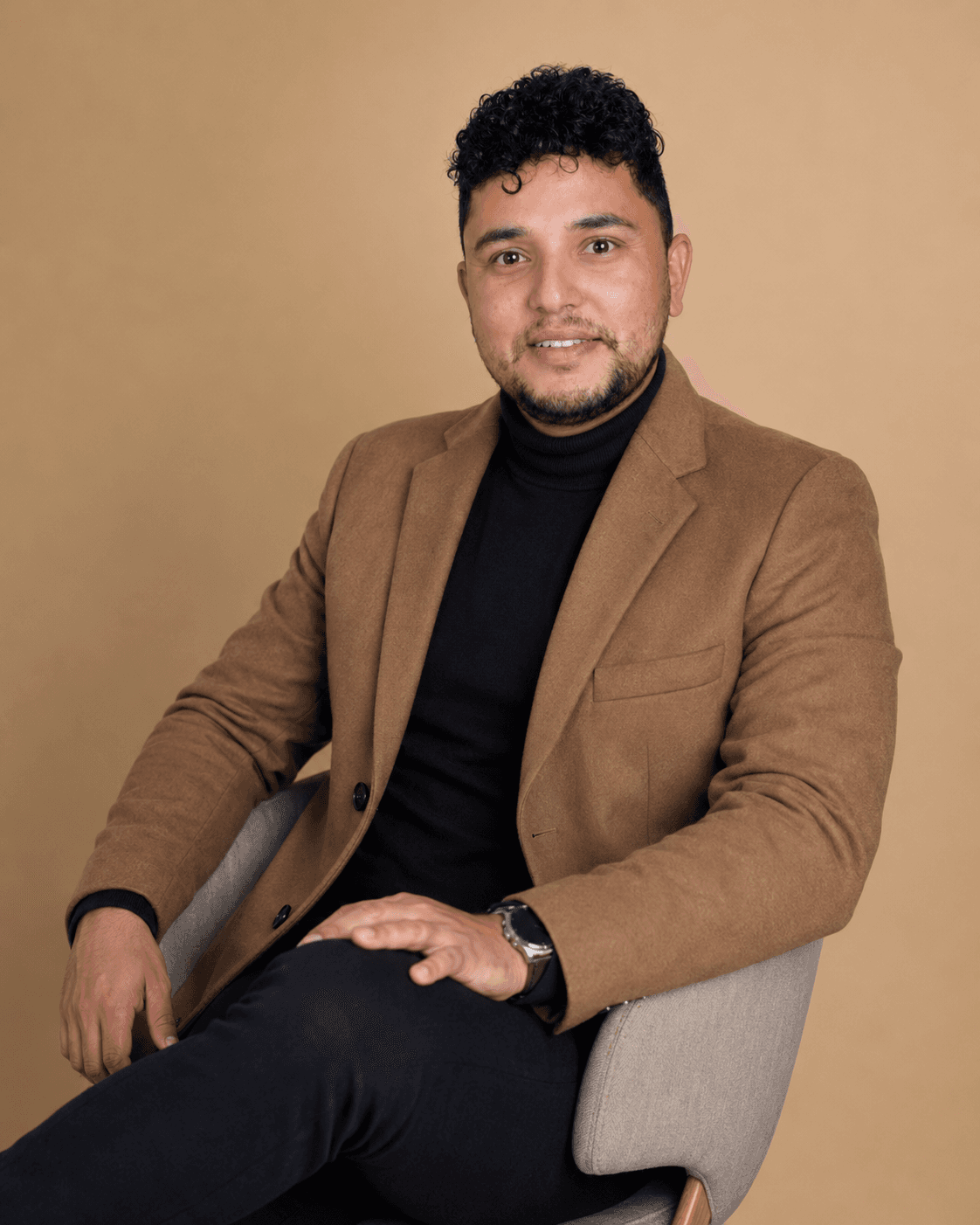 Rabin Paudel seated in a tan blazer